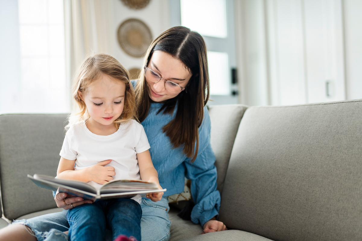 Nanny schaut sich mit dem Kind ein Buch an